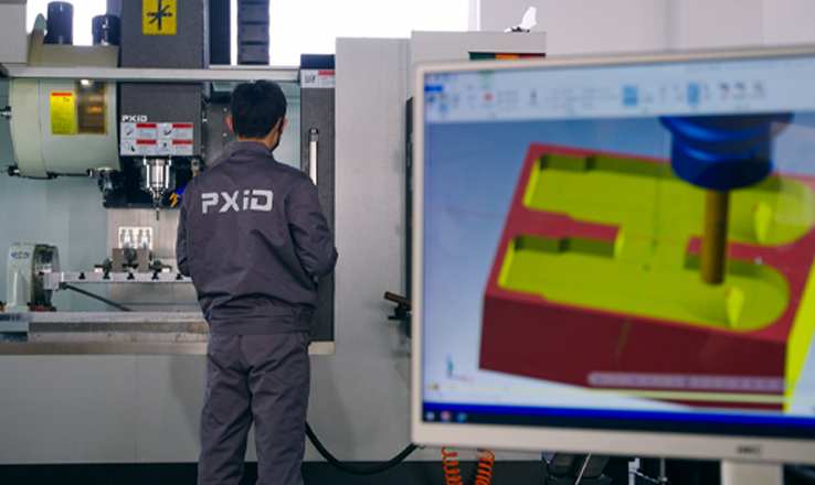 PXID prototype development — engineers testing a rideable e-bike prototype in the workshop